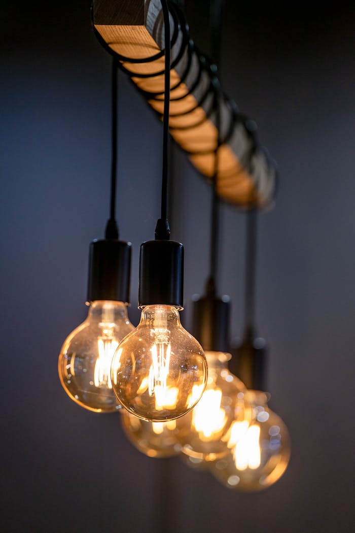 Close-up of glowing Edison bulbs hanging in a row with a warm light ambiance.
